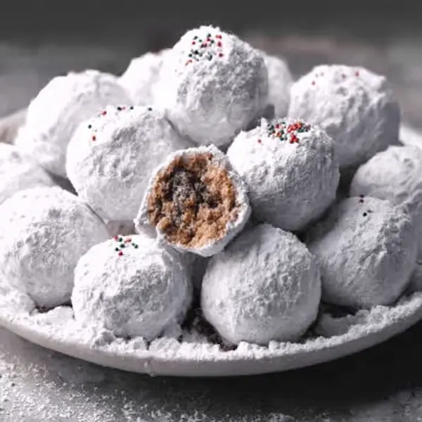Collage of no-bake Christmas desserts including Muddy Buddy Truffles, peppermint bark, cheesecake cups, and fudge.