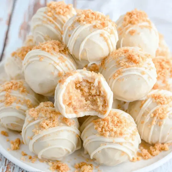 Assorted snickerdoodle cookie dough truffles coated in chocolate and cinnamon sugar for holiday dessert boards